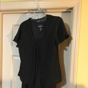 Long black sleeveless dress with sheer top.